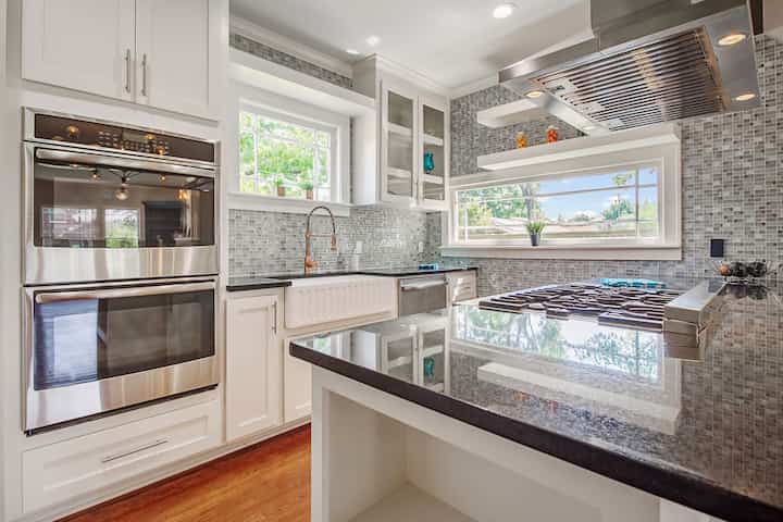 An image of a modern kitchen with sleek appliances, featuring a gas stove, refrigerator, and built-in microwave in Stillwater